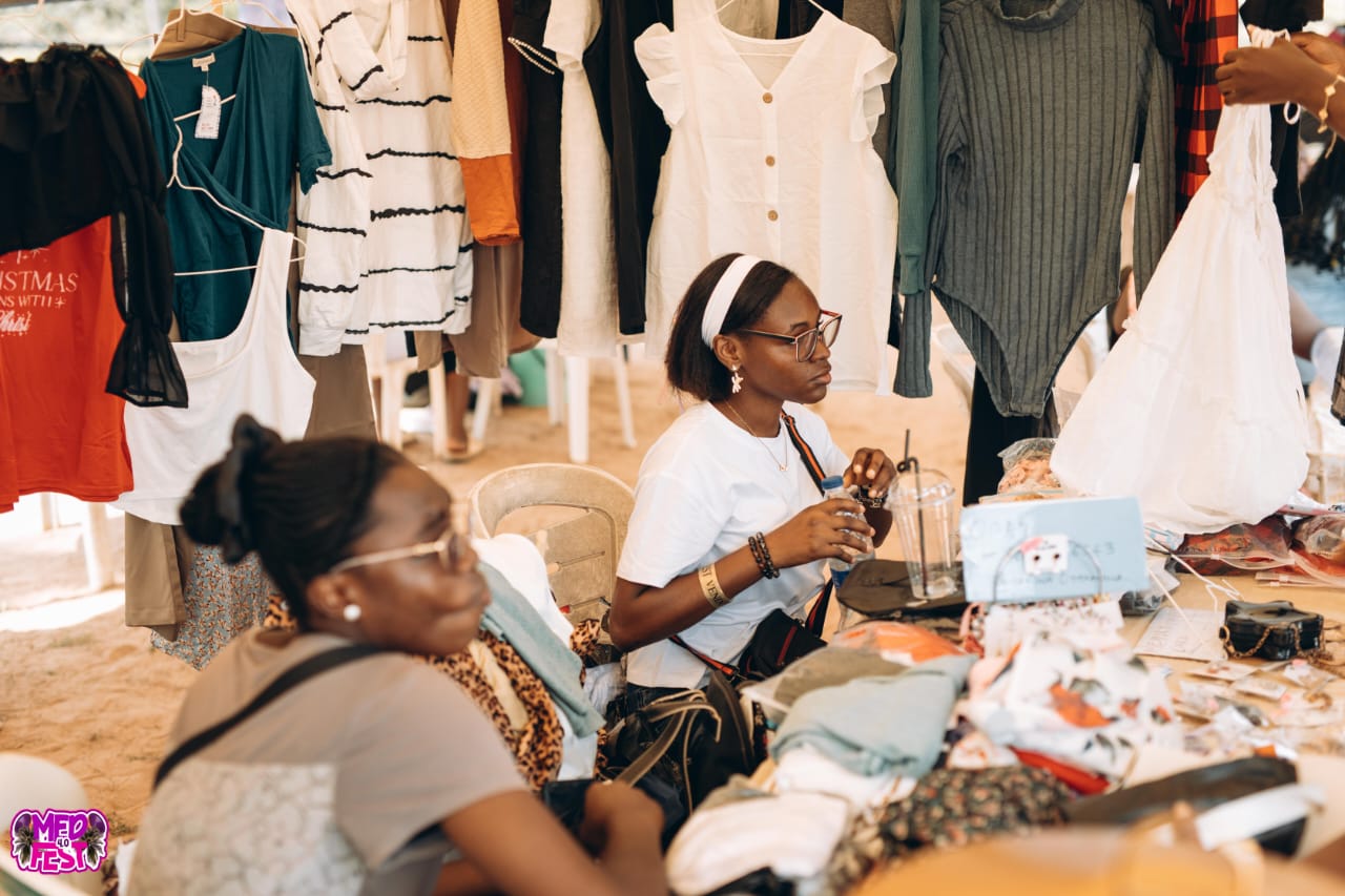 A vendor arranging clothes at a stall